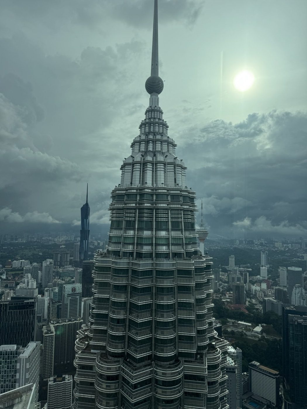 Petronas Tower spire with the Kuala Lumpur skyline